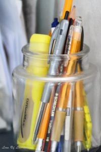 A photo of pens in a jar taken in a very dark environment at ISO 6400