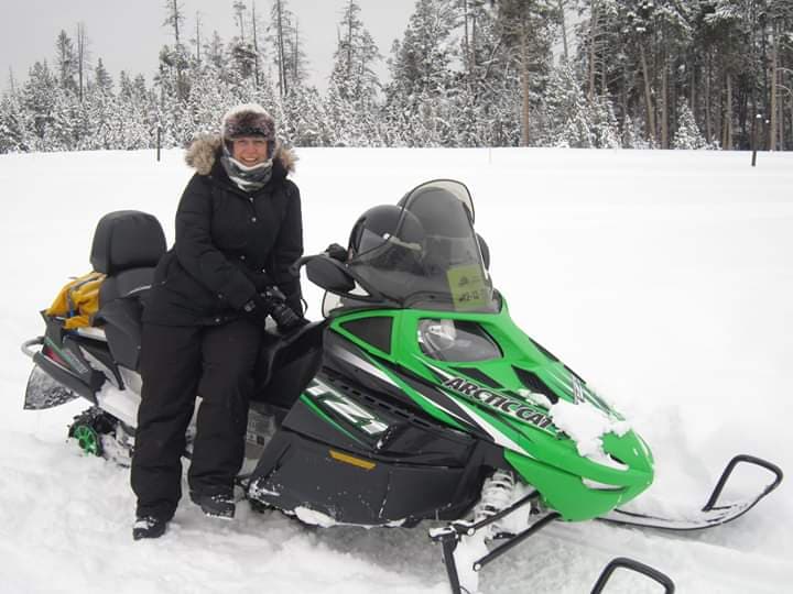 Cold Weather Photography Tips Tracey Lund with snow mobile