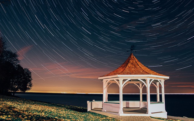A photograph of star trails with a light painted pavilion in foreground to add interest to the image