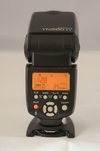 The rear view as seen by the photographer of the Yongnuo 560IV speed light showing the controls and settings panel