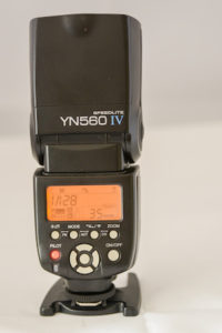 Yongnuo 560IV speed-light showing rear panel controls and flash pointing directly upwards